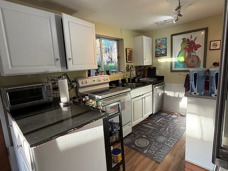 Kitchen: appliances: oven, new fridge, air fryer, microwave and toaster oven