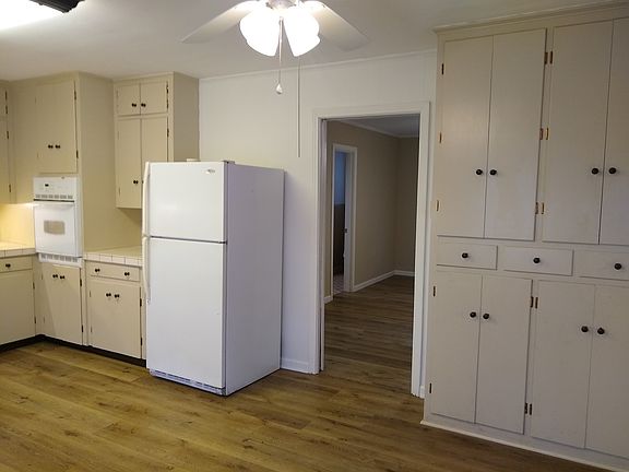 Kitchen area, left side view with fridge and extra storage cabinets.