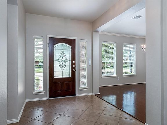 A beautiful leaded glass door with sidelights, and large pictures windows in the formal dining space allows the natural light to flow into the home!