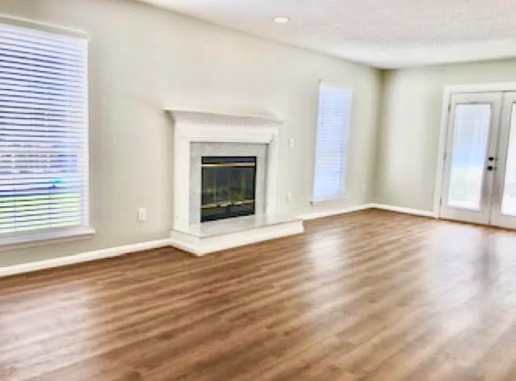 Family Room with gas fire place and french doors into the back yard.