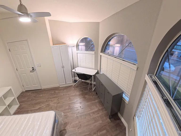 Comfy room with new memory foam bed, desk, LED lighting, ample storage & scenic views through 3 tinted street-facing windows.