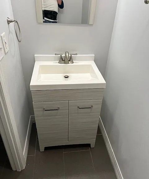 First floor .5, one half Bathroom Powder Room: Vanity, Mirror, Light, Exhaust Fan with added Light, Tile and Grout Flooring, Freshly Painted Ceiling, Walls, Baseboards and Moldings.
