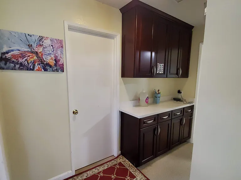 Guest bathroom & laundy isle opposite to washer & dryer