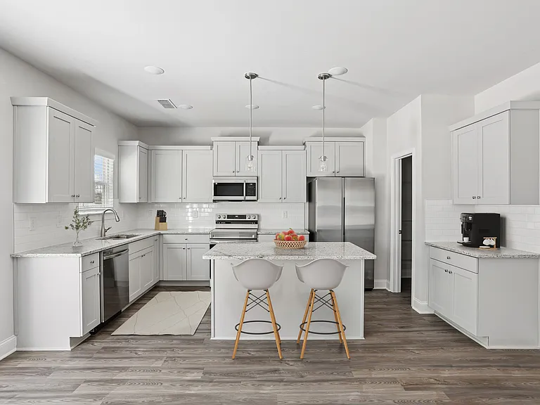 Spacious kitchen with an island, ample storage, and stainless steel appliances.