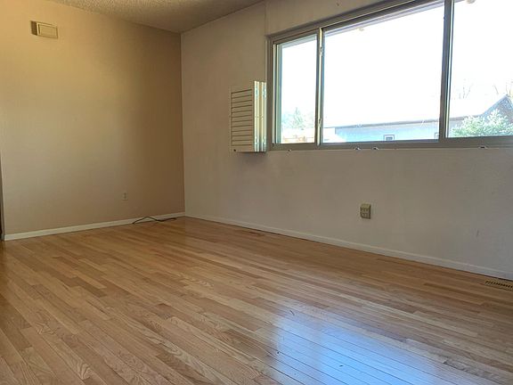 Living room with hardwood floors and lots of natural light.