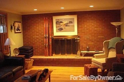 Large living room
						:
						Living room with one brick wall with a working fireplace and
seat.