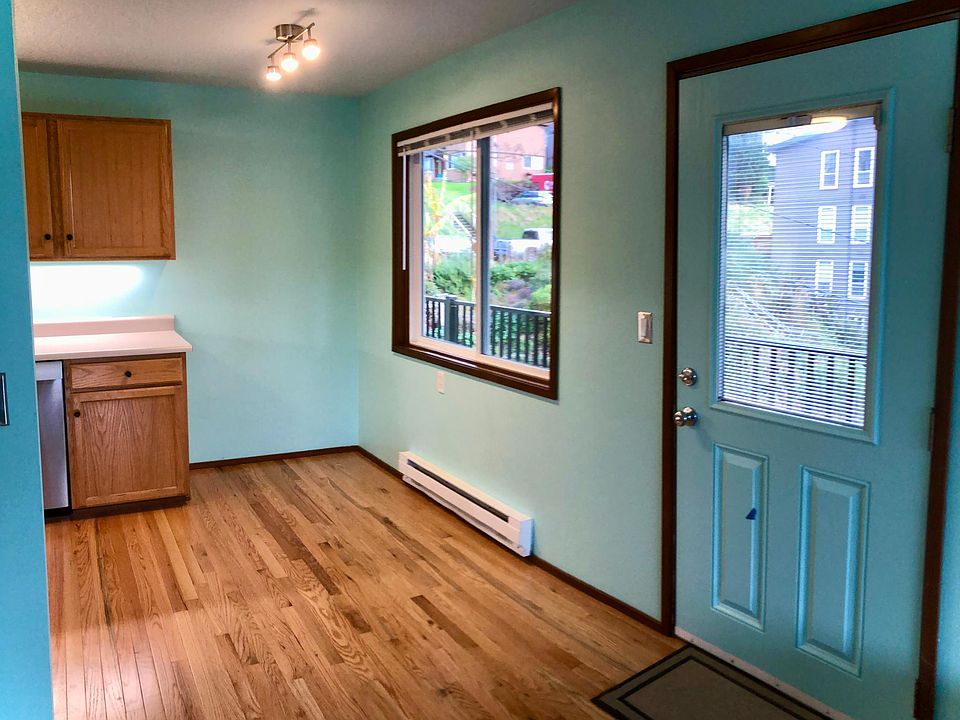 Dining area and entry door, with adjustable blinds built into door window.