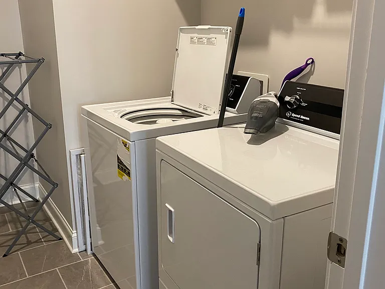 Speed Queen washer and dryer on main floor off garage entrance.