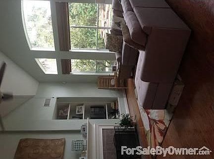 Spacious Living Room looking at Pool
						:
						Vaulted ceiling, gas fireplace w gas logs, built-in shelves, open to 2nd story