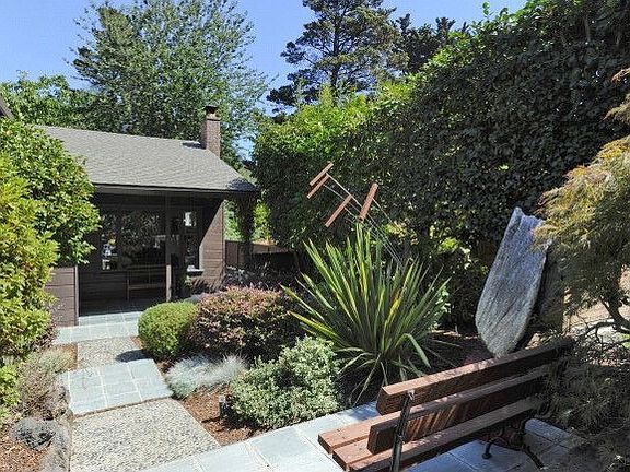 Outdoor art and benches as you approach the house