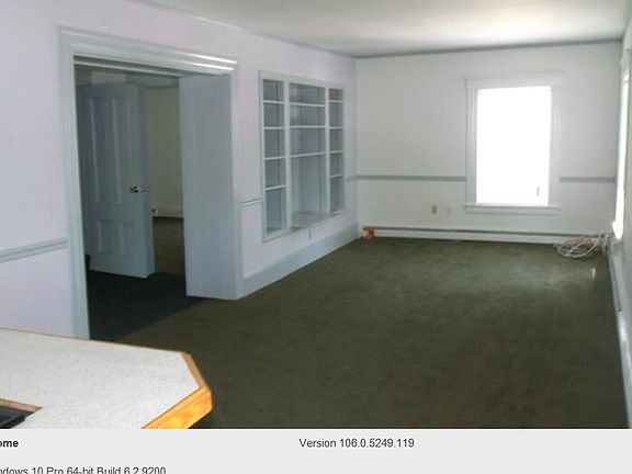 The main living/dining area without the current furnishings that provides a good view/idea of the space