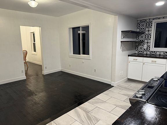 Adjacent to the kitchen is this big breakfast nook. It's the perfect place to cuddle up with a cup of coffee and look out one of the biggest windows in the home.