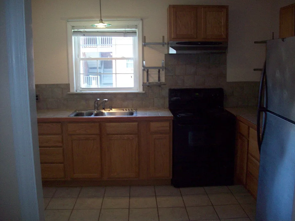 Kitchen, tumbled marble counter and backsplash, new cabinets, garbage disp.
