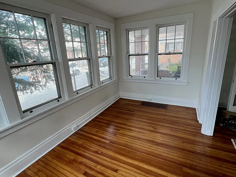 Beautiful sun room with refinished hardwood floor.