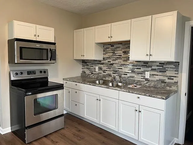 Whirlpool range and microwave. New cabinets and backsplash.