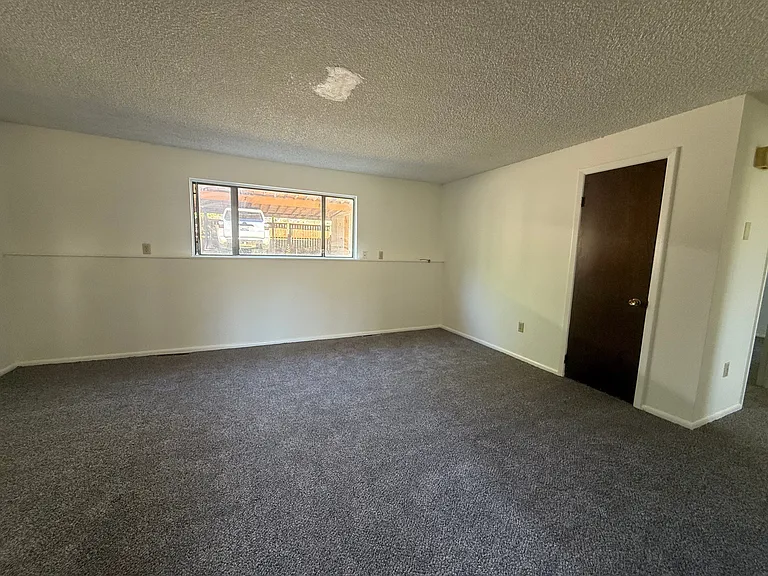 Livingroom view from common area entrance door - new carpet and paint summer 2026.