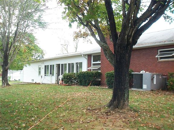 An enclosed porch on the back has modern windows and ceramic tile floors.
