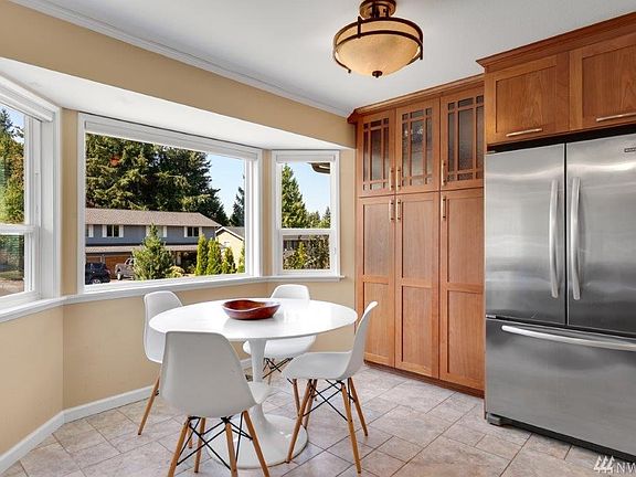 This sunny bay window in the dining nook is another great gathering place. You'll find ample extra storage in the pantry cabinets with beautiful, lighted glass-door cabinets above. The home has been updated with vinyl windows.