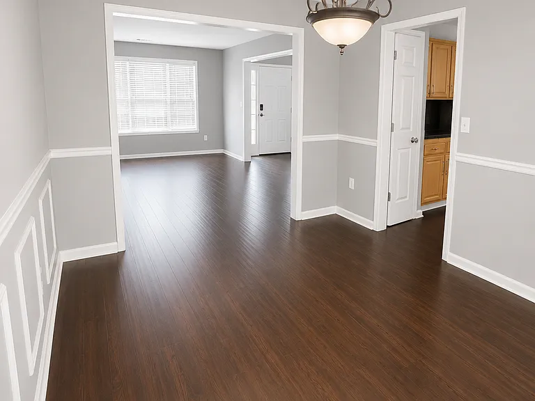 Elegant dining room with decorative trim and modern lighting, perfect for everyday meals or hosting family gatherings.