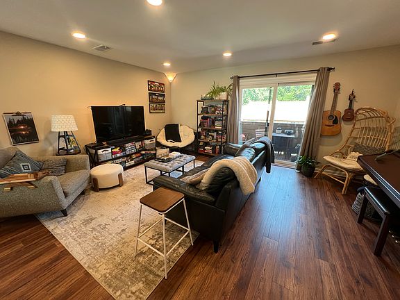 Living Space w/ dimmable overhead lighting. Exterior patio through sliding glass door. 
(furnishing not included)
