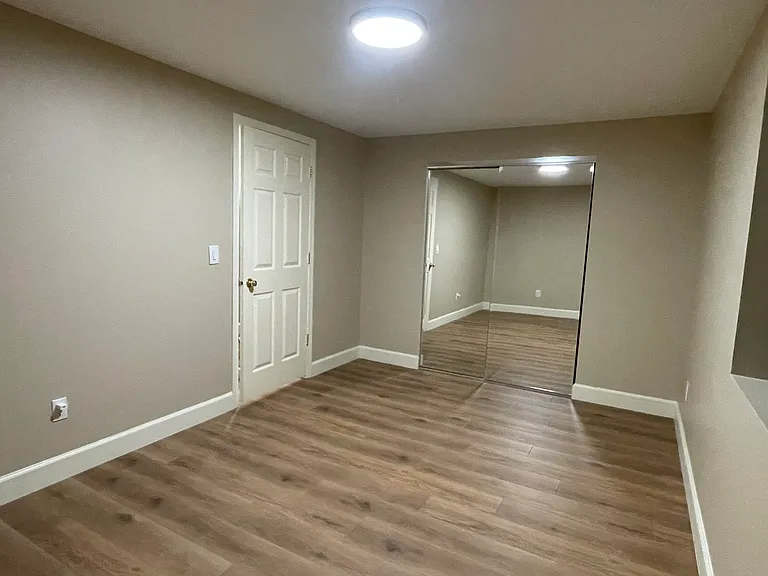 Bedroom with mirrored sliding closet doors