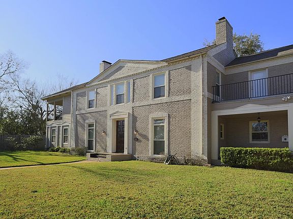 Home has two 2nd floor balconies with great views of the city and expansive front and back yards.