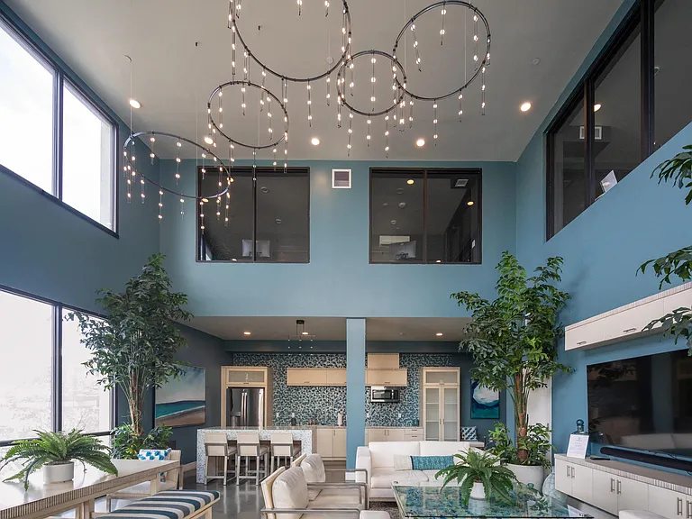 Bright lounge with large windows, open seating, and modern lighting that enhances the airy layout.