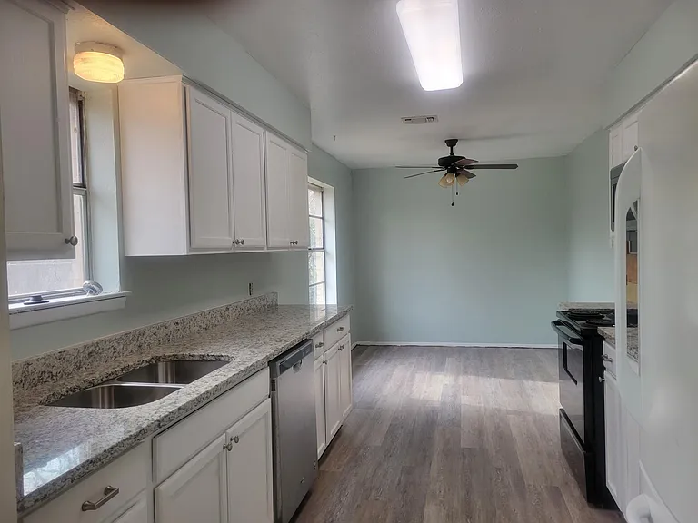 Updated kitchen with granite countertops, undermount sink, built in microwave/vent. dishwasher and eating area,