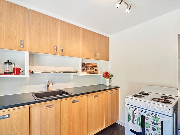 Kitchen with range, fridge/freezer, and plenty of counter space/storage.