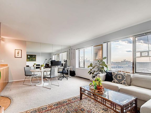 Large open living space with full wall of windows.