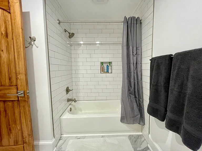 Fully Renovated New Bathroom with Subway Tiled Tub & Shower, New Toilet. New Granite Sink Countertop. New LVT Flooring. Freshly Painted.