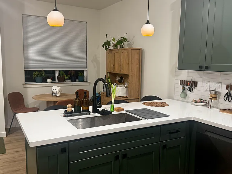 Spacious kitchen with large island sink, ample cabinetry, and adjacent dining nook for everyday meals.
