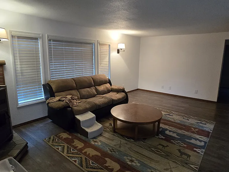 Living Room..couch and coffee table to be removed. Rug is optional if renter wants to use it.