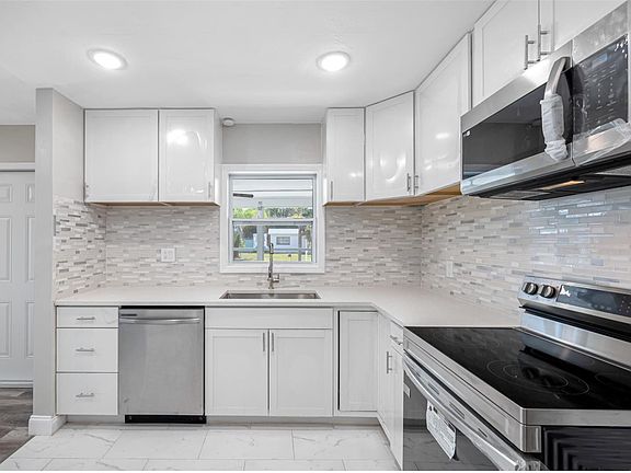 Kitchen sink overlooking the front porch/ Florida room