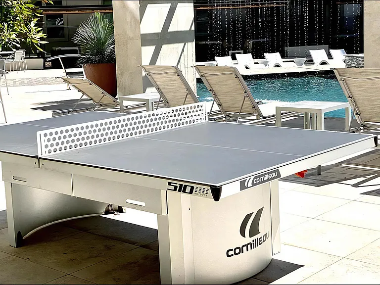 Table Tennis Setup in Courtyard Overlooking Resort-Style Pool