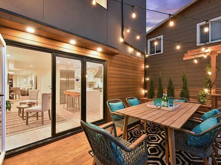 Backyard deck overlooking a beautiful garden with a waterfall