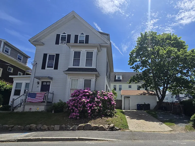 Front of house. Parking for one car is available on the left side of the driveway.