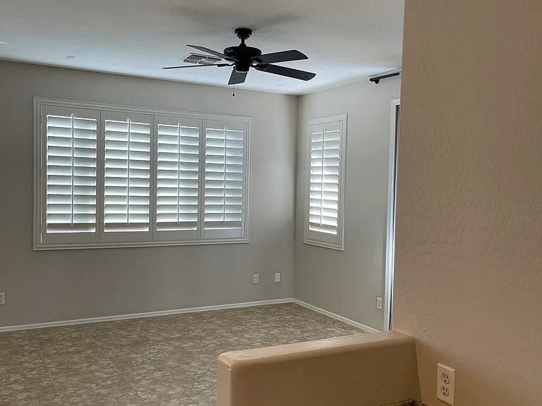 Family room with windows to backyard. Also showing small desk/work area across from kitchen island.