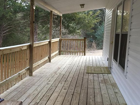 rear deck with a woodland view