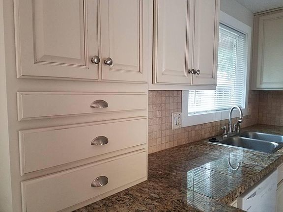 Antique glazed cabinets, granite counters, travertine backsp