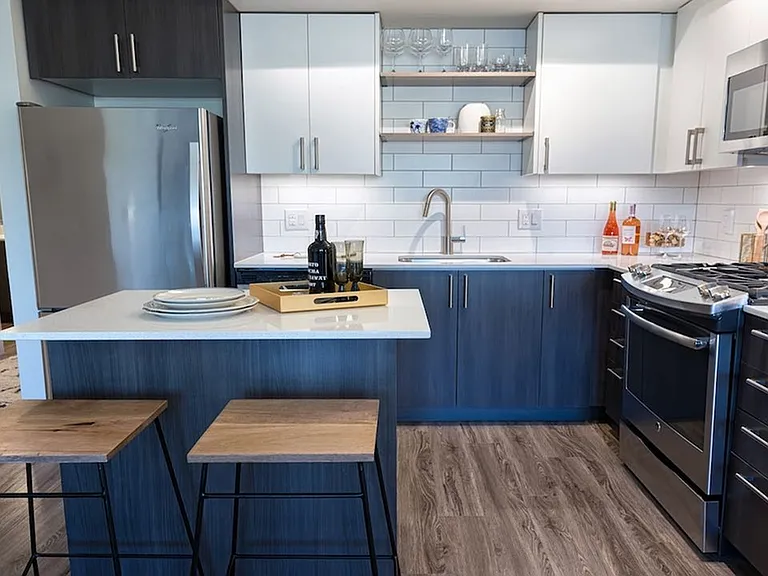 Our kitchens feature high-end finishes including stainless steel appliances and quartz countertops