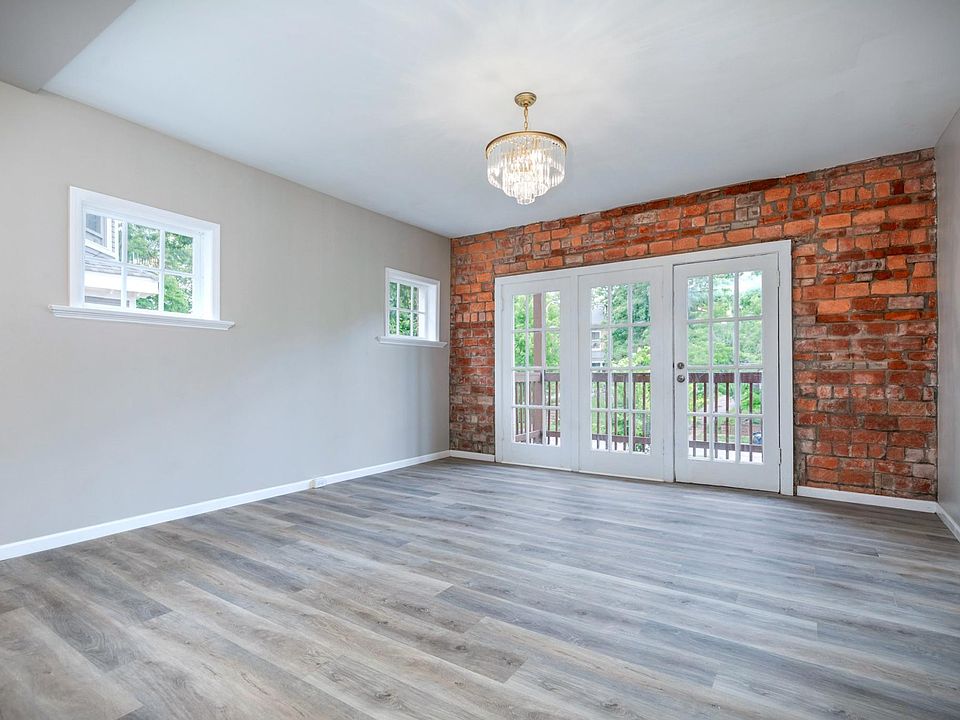 Living Room w/ original exposed brick around walk-out balcony