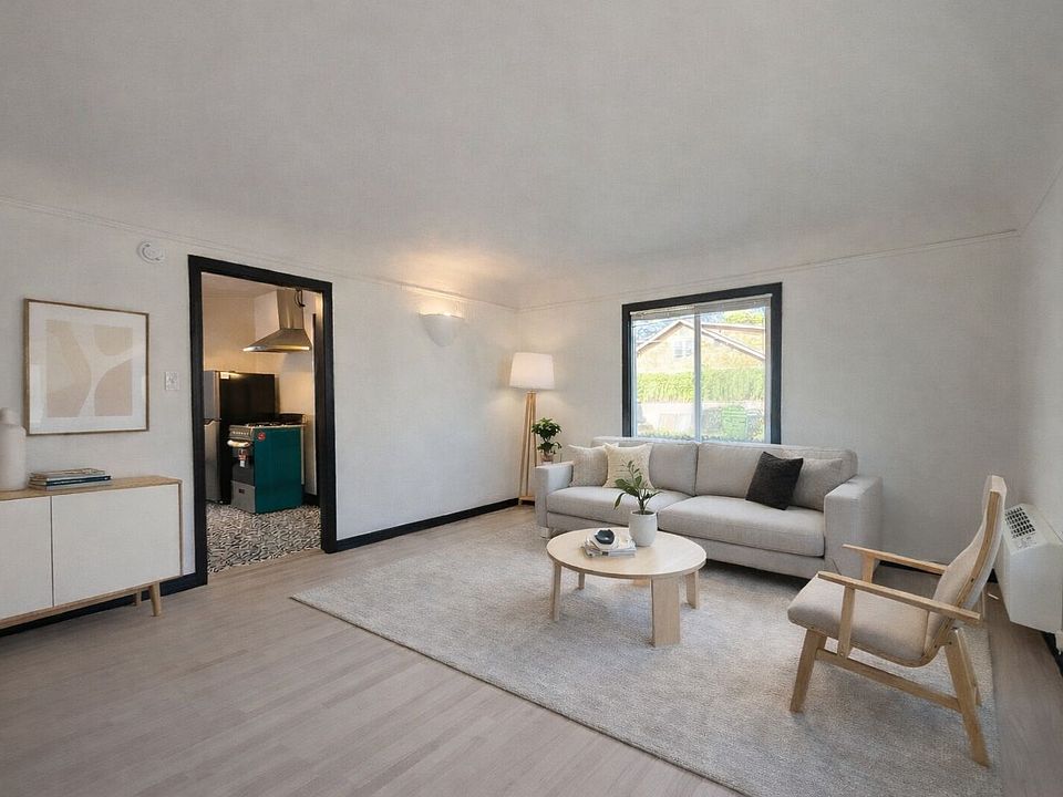 Staged living room - leads to kitchen - which leads to bedroom and bathroom