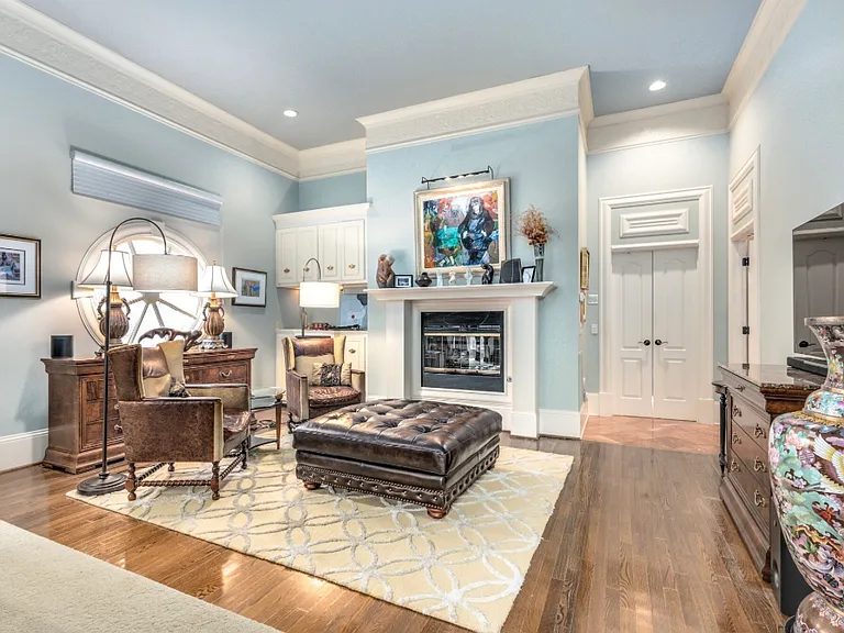 Master bedroom sitting area with double -sided fireplace that also opens to master bath