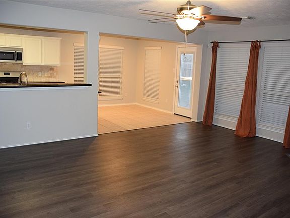 Gorgeous laminate flooring is so easy to maintain after entertaining guests in this open floor plan!