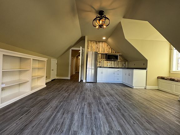 Living room area with new flooring toward hallway accessing bath and bedrooms.