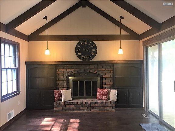 Family room with new floors and new ceiling. Fresh paint for open and light filled living space.  Fireplace has not been used by seller.  Sliding doors open to deck and shade covered back yard.