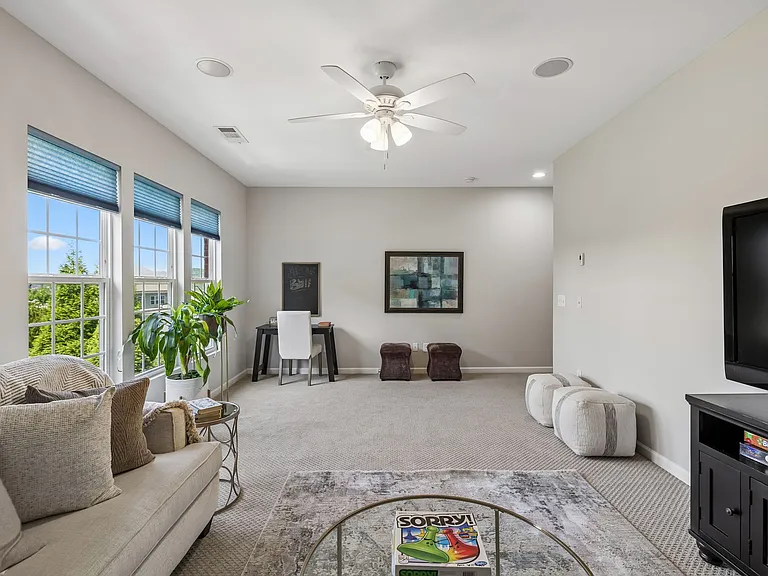Large windows fill the room with natural light while showcasing peaceful views overlooking the private, tree-lined backyard. With its generous dimensions and flexible layout, this versatile space easily adapts to your changing needs.