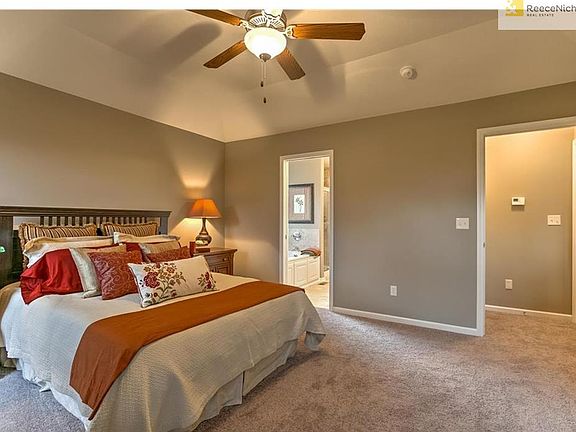 Master suite has elevated ceiling with ceiling fan.