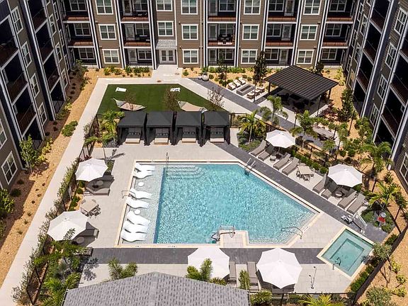 The courtyard pool includes a sun shelf with in-water loungers, a separate spa, and four private cabanas.